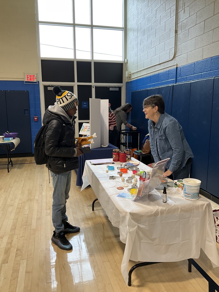 A student is talking to a rep at the wellness fair
