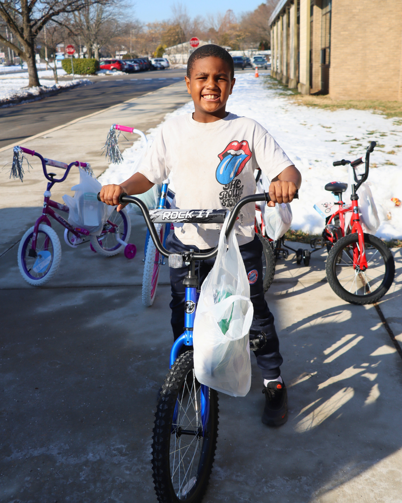 Student sitting on their new bike. 