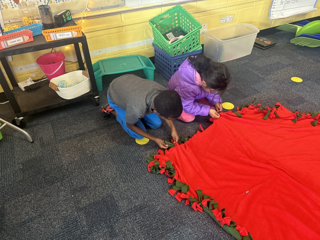 Two students working on a blanket together