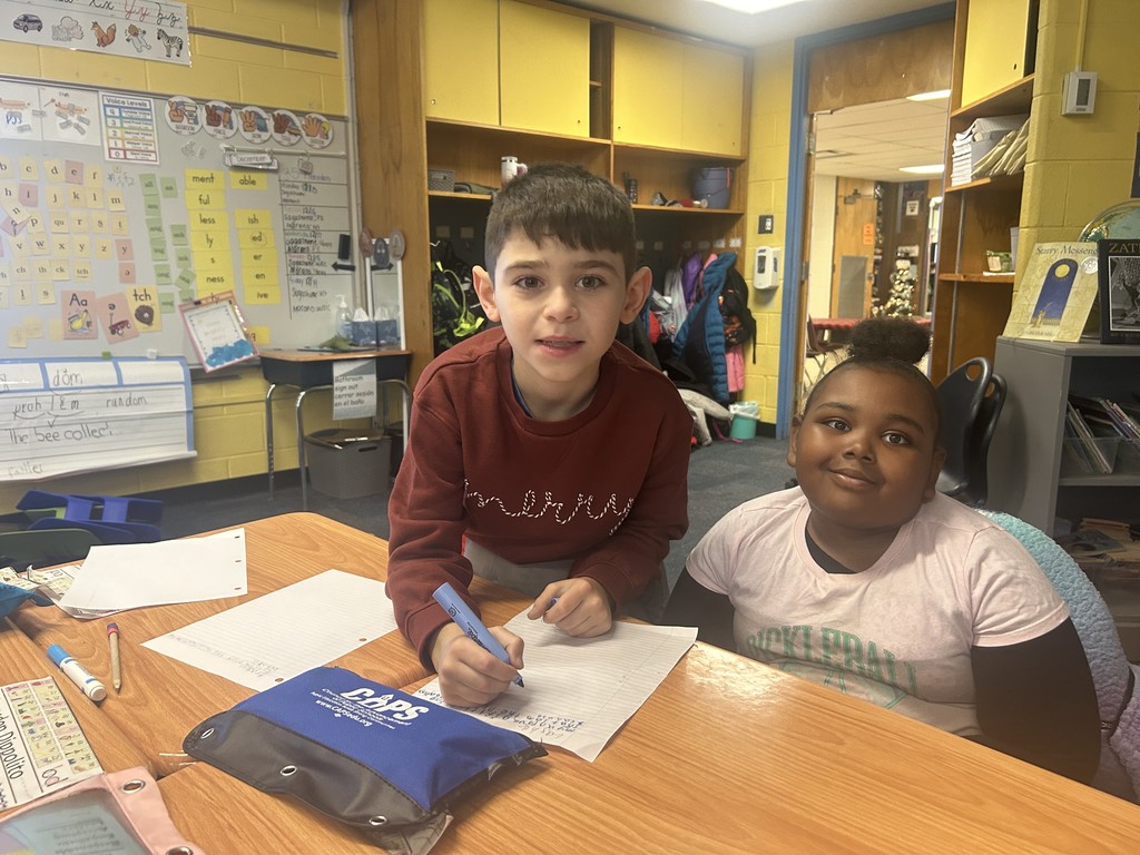 Two students working together to write down ideas about their special gifts