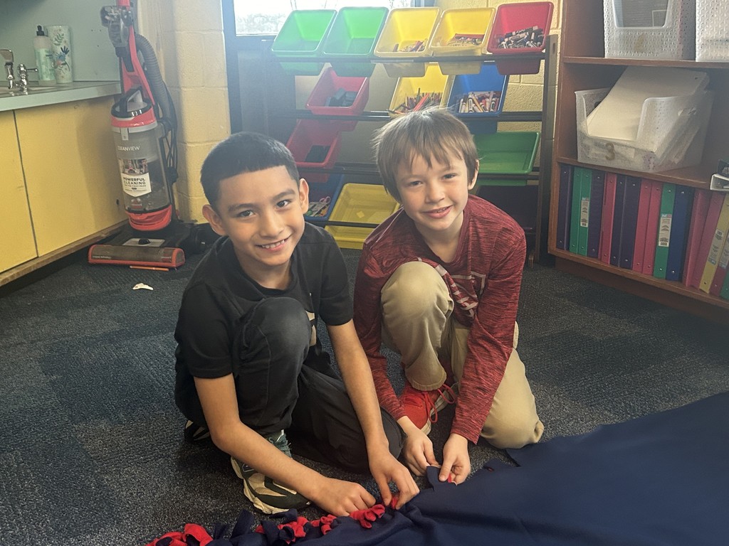 Two students working on a blanket together