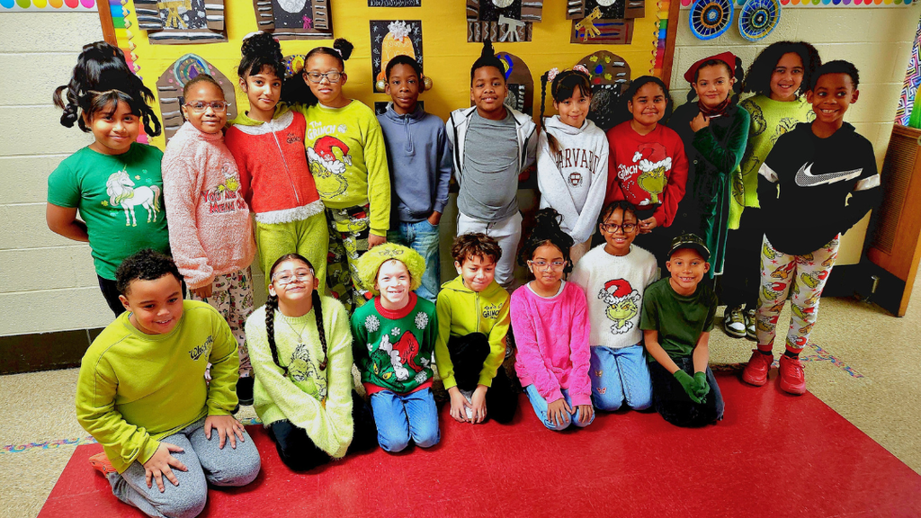 Students pose for group photo dressed up in festive outfits.