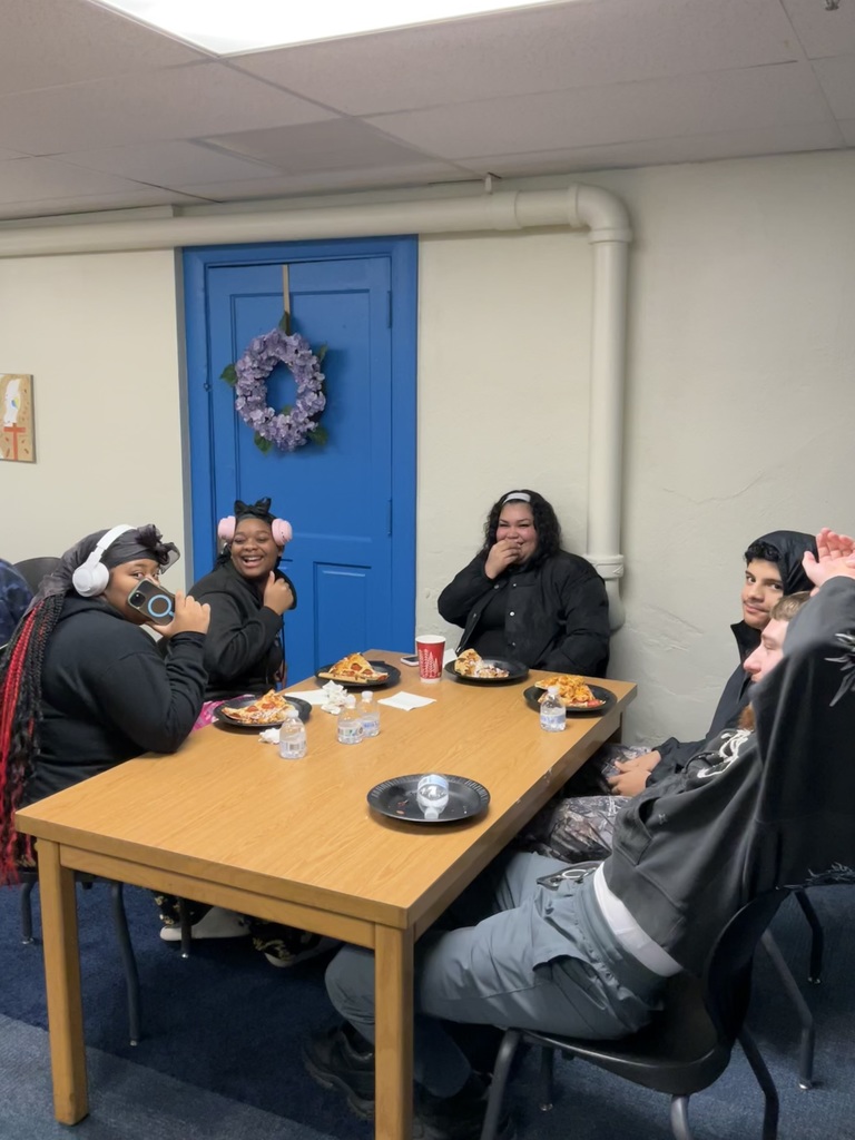 Students are sitting and eating together during the award assembly