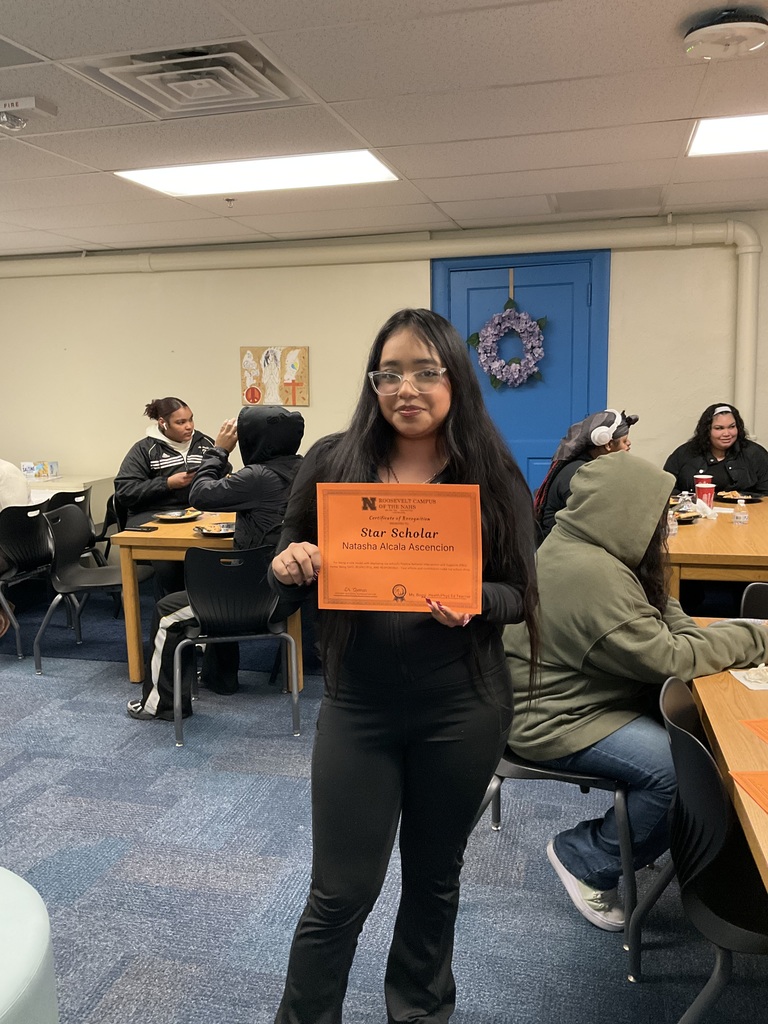 A student is posing with her award