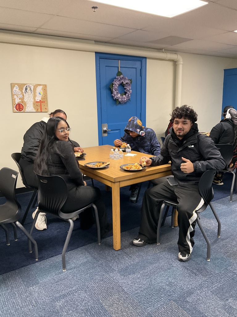Students are eating pizza together