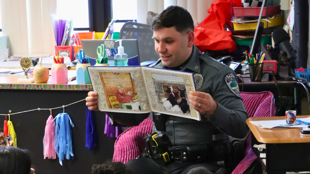 Officer Dinolfi showing the storybook to students. 
