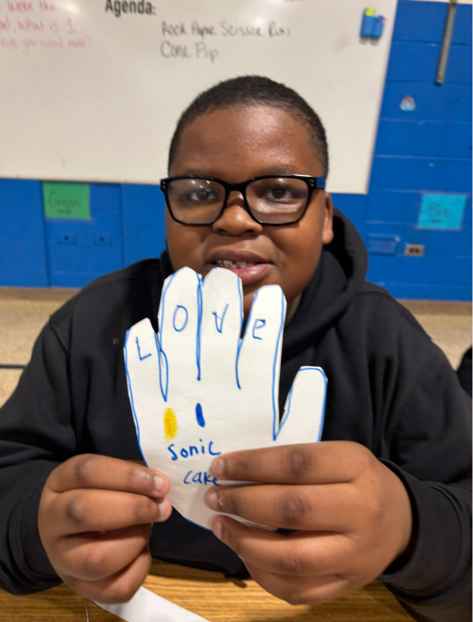 A student showing the hand he made for Martin Luther King Day