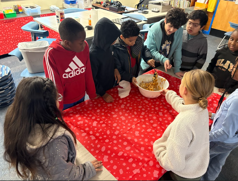 Students working together to measure ingredients