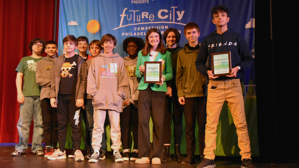 Group of students on stage at the Future Cities Competition.