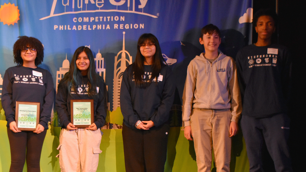 Five students on stage at the Future Cities Competition.
