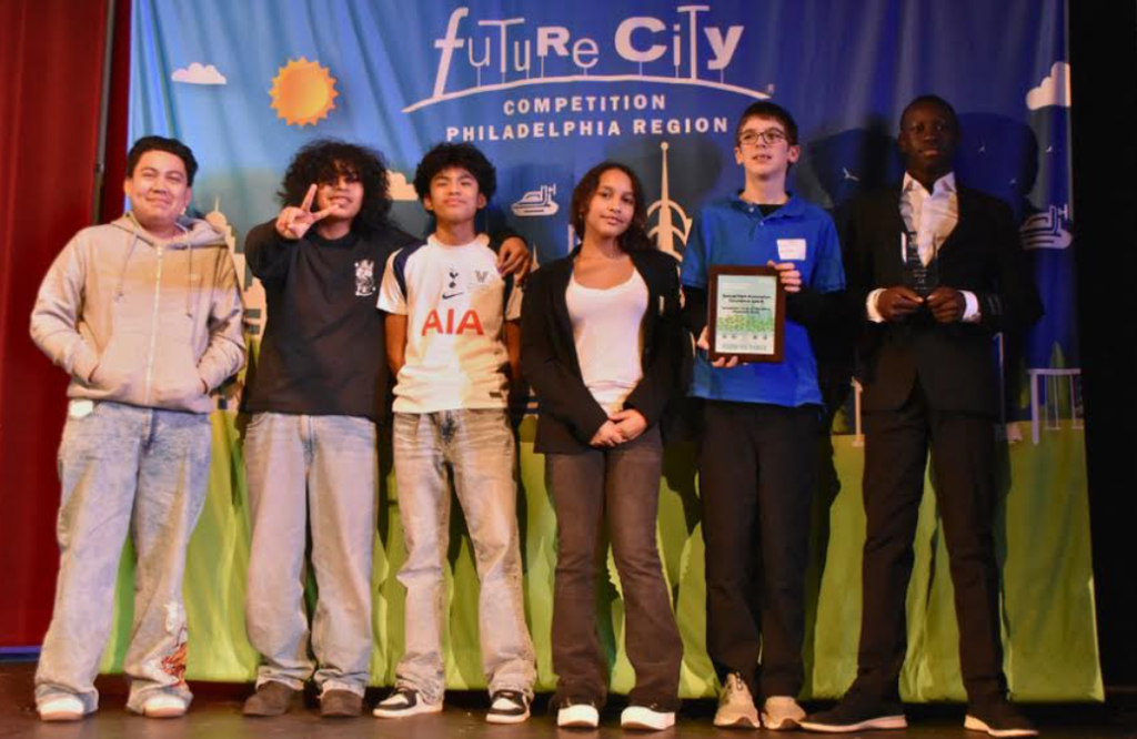 7th grade posing with their award at the Future City competition.