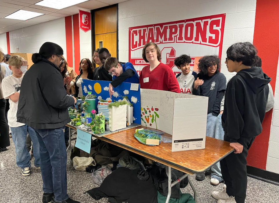 7th grade showing their display at the Future City competition.