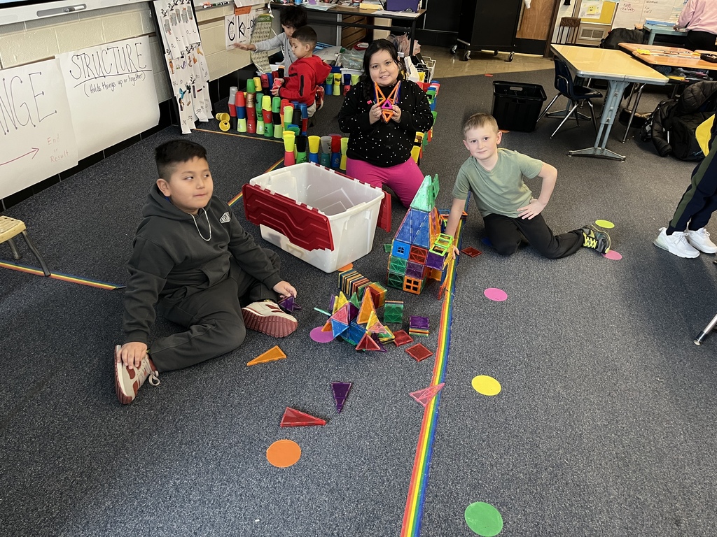 Second graders build with toys.