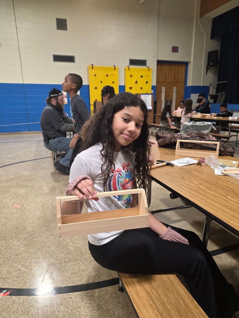A student showing her project at Scouts