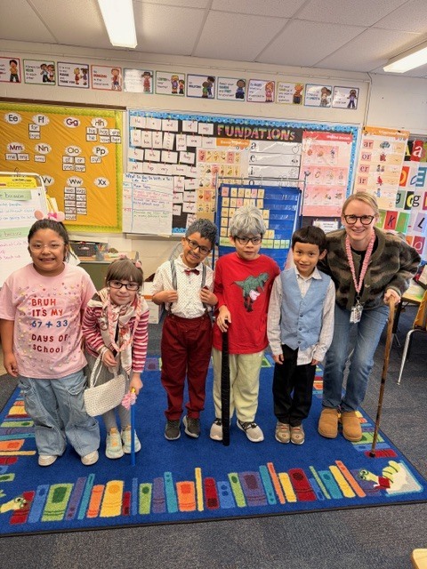 Mrs. Piskai and some of her first grade students