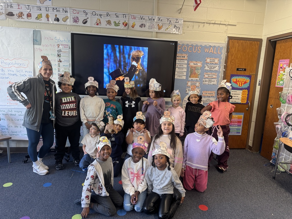 First graders celebrate Groundhog Day with special hats.
