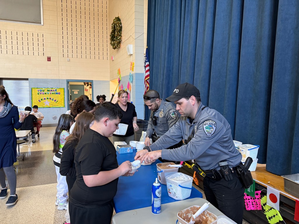 West Norriton Police Officers serving ice cream to the 4th Gaders.