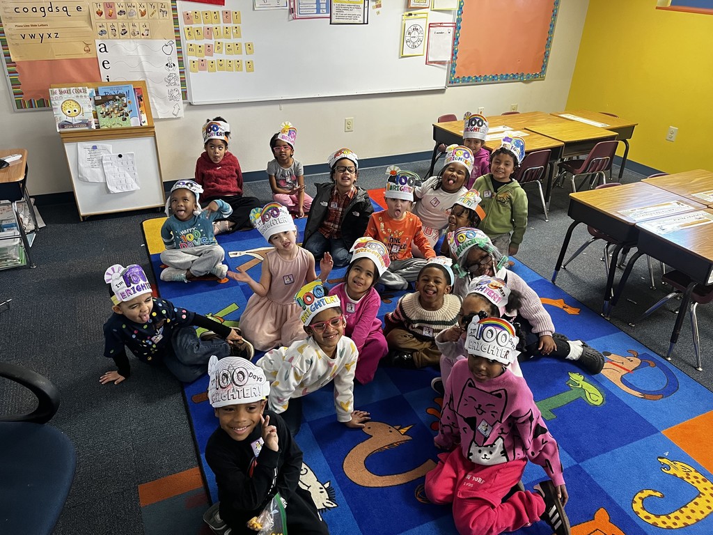 students sitting on carpet for 100th day of school