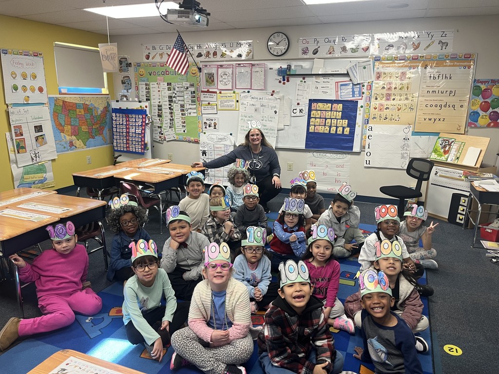 class sitting on carpet for photo