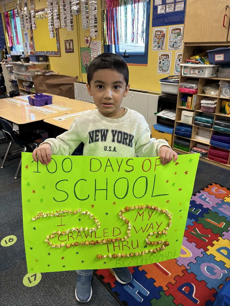 student holding 100th day of school project