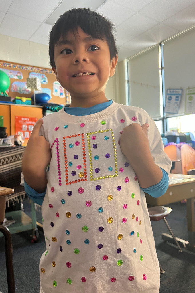 A student dressed in a 100th Day of School shirt.