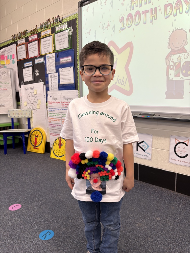 A student dressed in a 100th Day of School shirt.