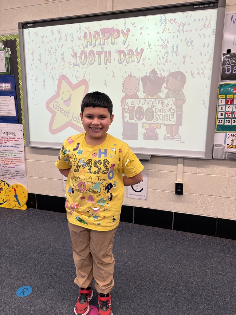 A student dressed in a 100th Day of School shirt.