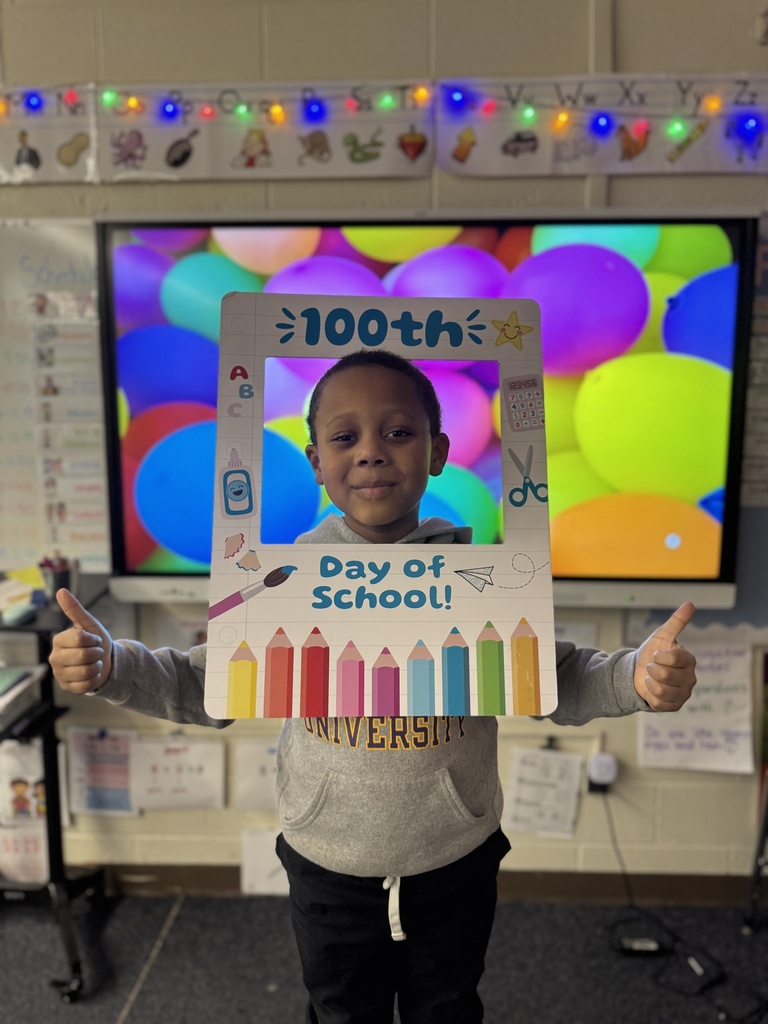 A student poses with a special frame to celebrate the 100th Day of School.