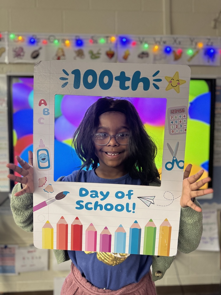A student poses with a special frame to celebrate the 100th Day of School.