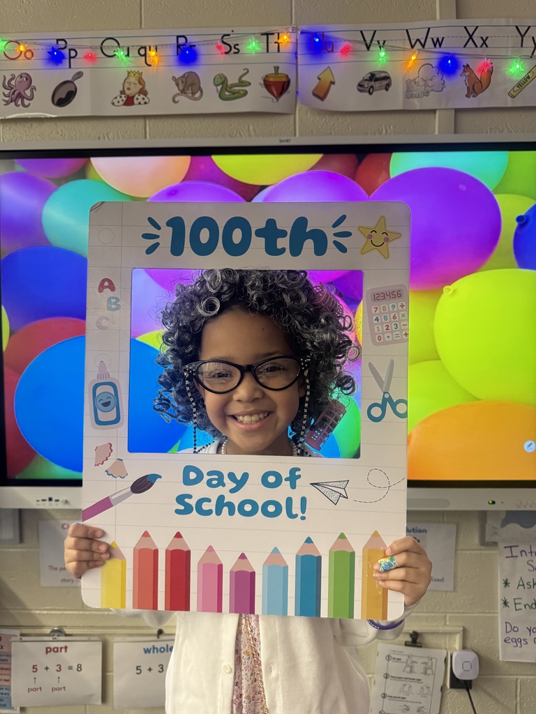 A student poses with a special frame to celebrate the 100th Day of School.