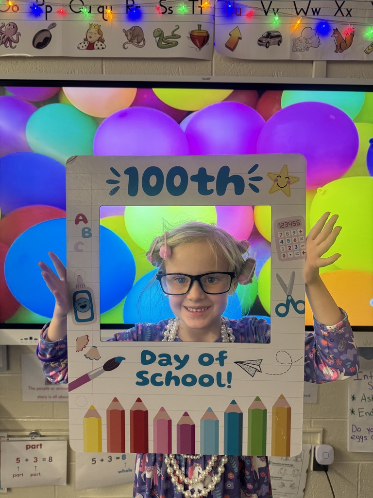A student poses with a special frame to celebrate the 100th Day of School.
