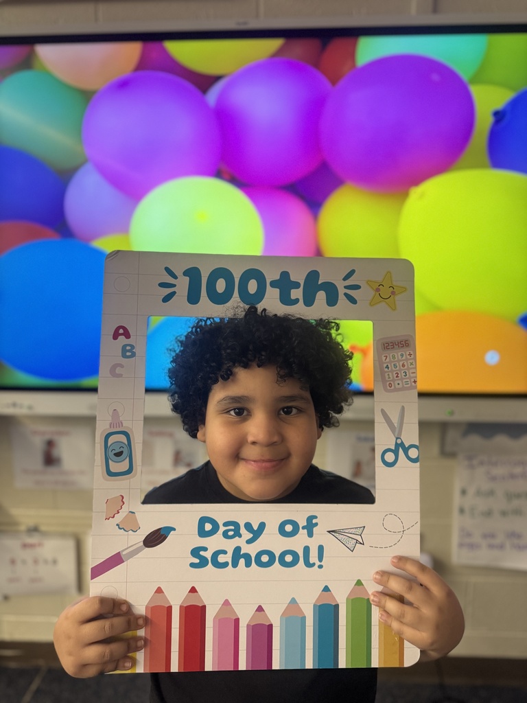 A student poses with a special frame to celebrate the 100th Day of School.