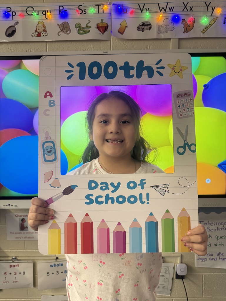 A student poses with a special frame to celebrate the 100th Day of School.