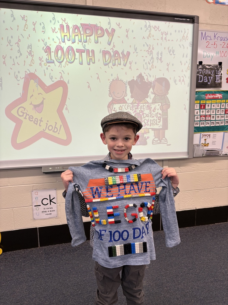A student shows his 100th Day project.