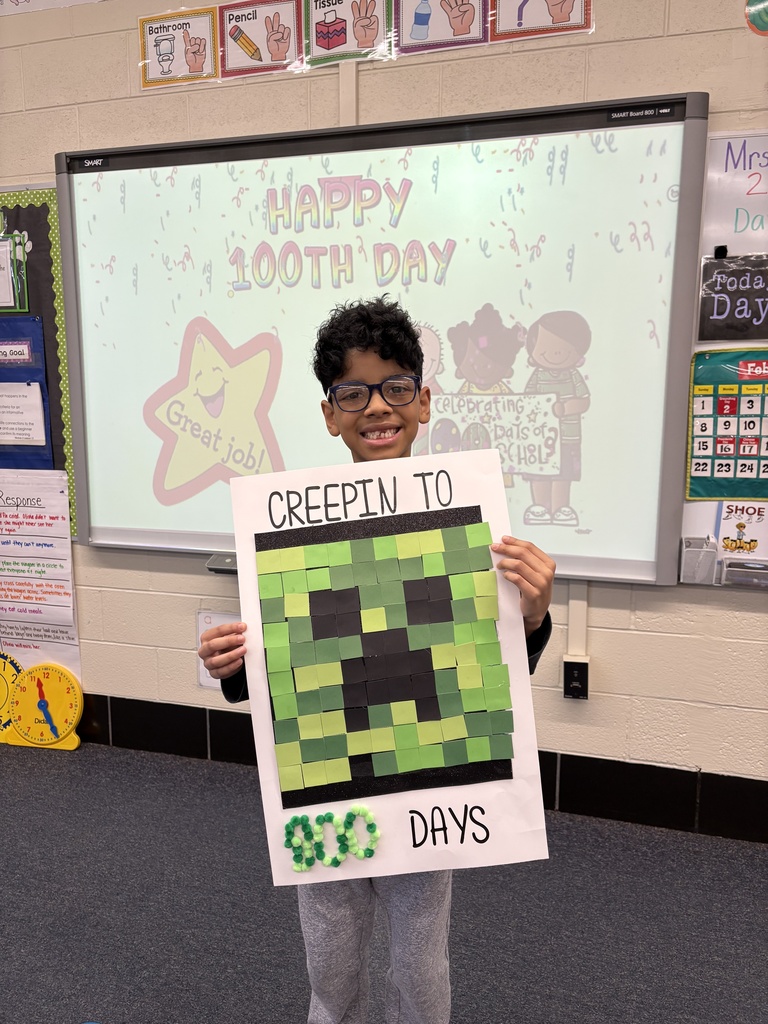 A student shows his 100th Day project.