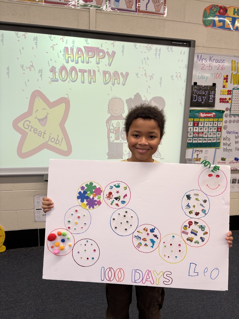 A student shows his 100th Day project.