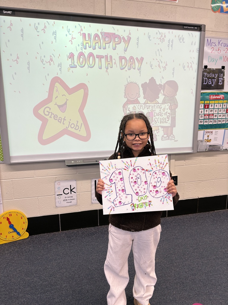 A student shows her 100th Day project.
