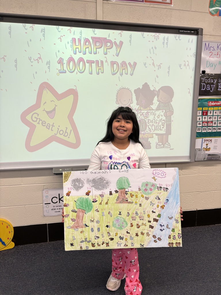 A student shows her 100th Day project.