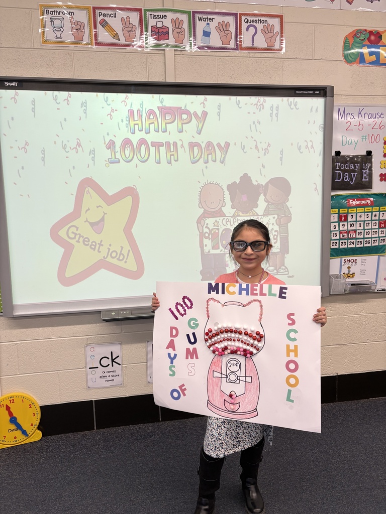 A student shows her 100th Day project.