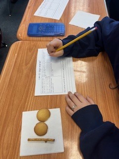 Fourth graders enjoy a 100th Day snack while doing a 100th Day writing.