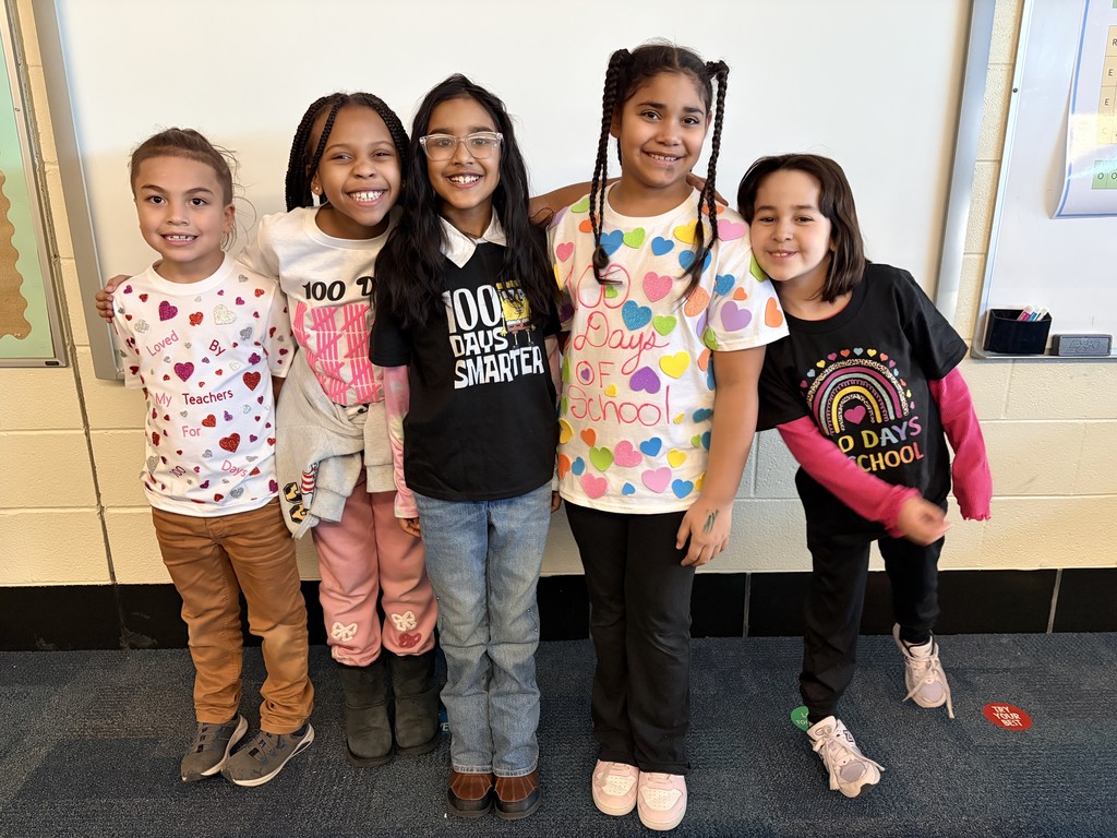 Third graders show their 100th Day of School shirts.