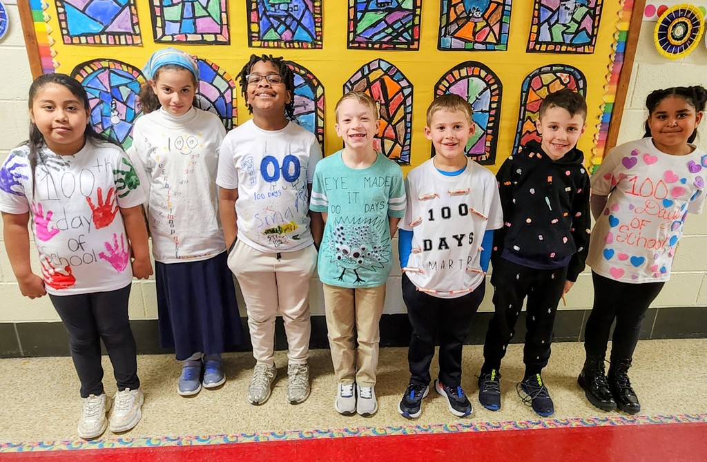 Third graders show their 100th Day of School shirts.