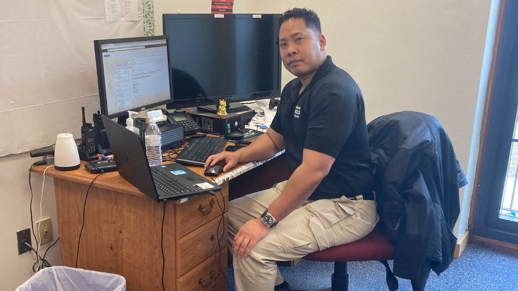 School Resource Officer sitting at their desk posing for photo.