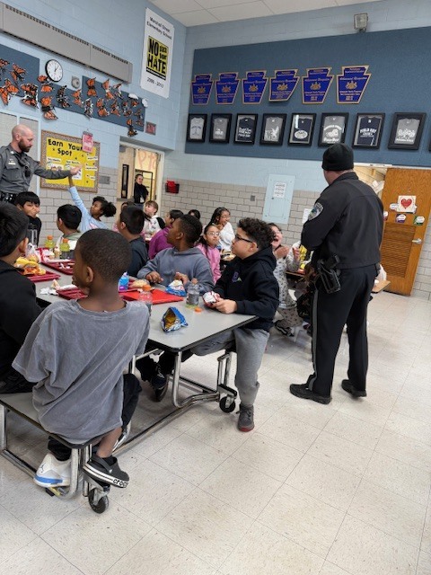 West Norriton Township police officers visit fourth graders and bring pizza for lunch.