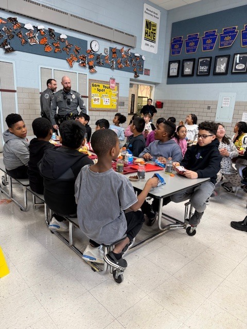 West Norriton Township police officers visit fourth graders and bring pizza for lunch.