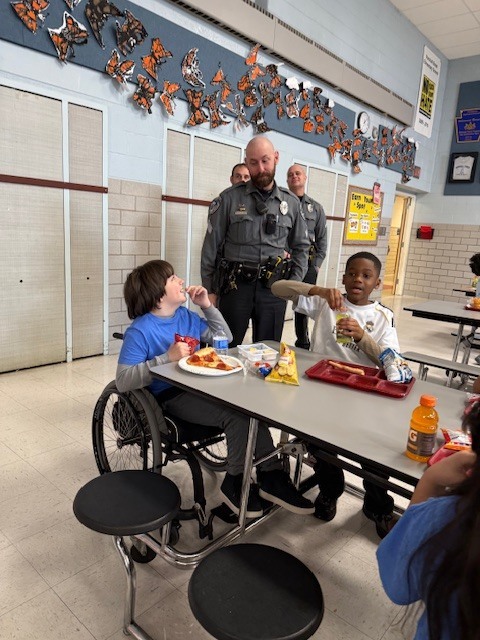 West Norriton Township police officers visit fourth graders and bring pizza for lunch.
