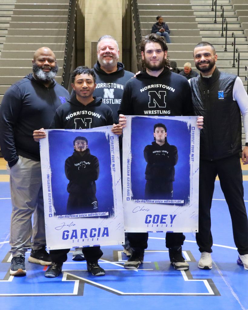 NAHS Wrestling coaches pose with seniors.