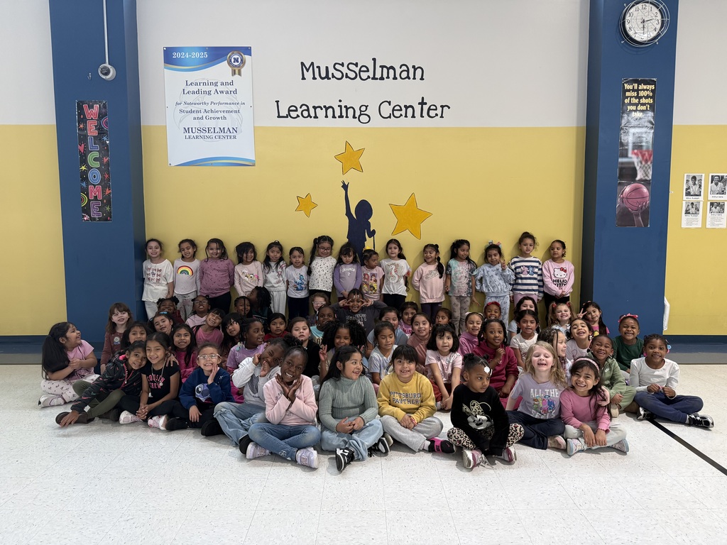 students in front of Musselman learning sign
