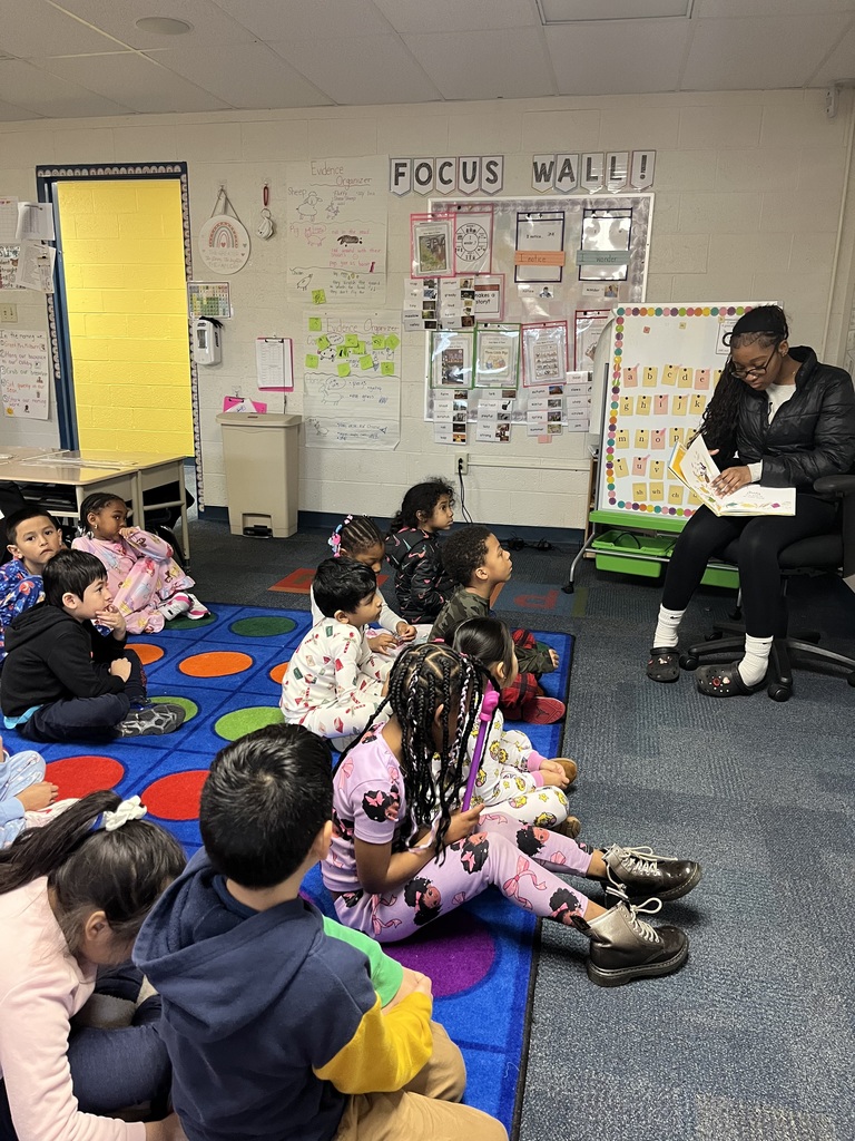 students listening to a story on the carpet