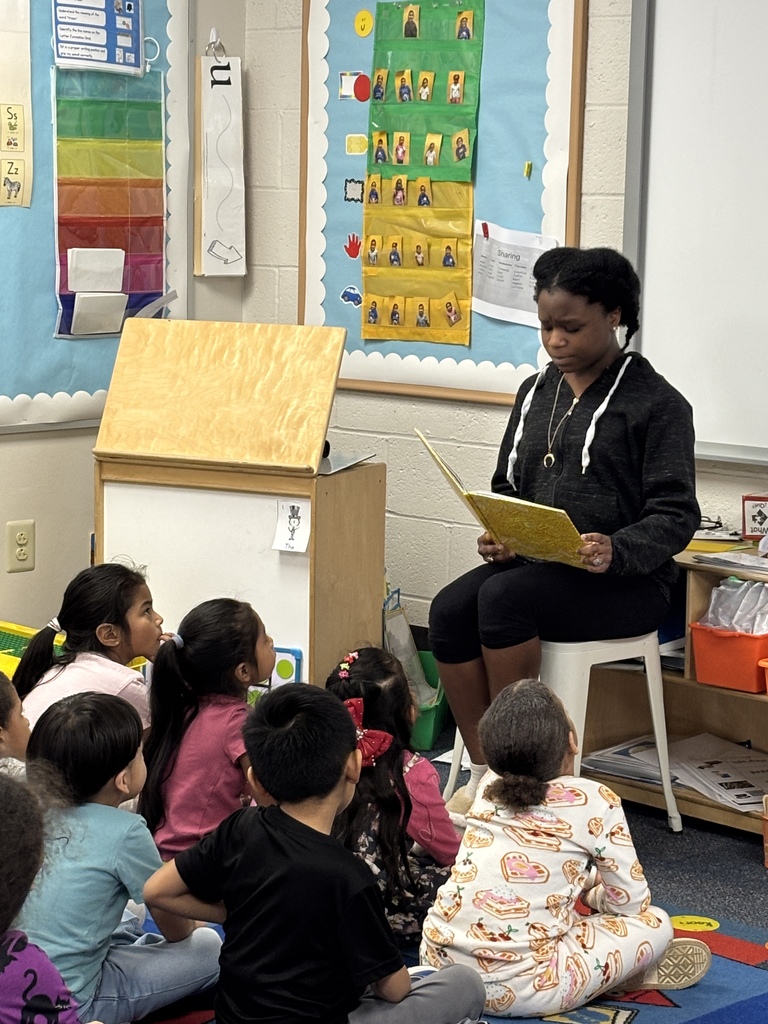 students listening to a story on the carpet